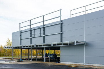 Unfinished metal frame warehouse building facade covered with thermally insulated sandwich panels
