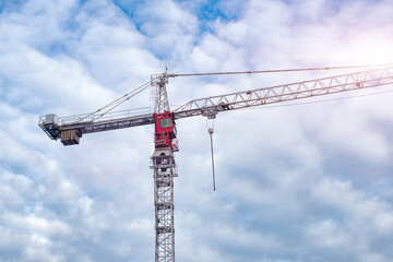 Construction Tower Crane against a blue sky background. High lifting tower crane. The concept of building and construction. Construction of urban structure. 