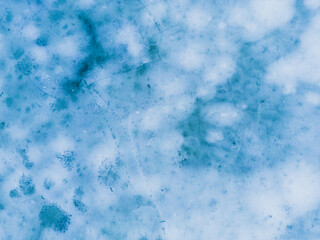 Aerial view of a frozen lake. Ice sheet background. Frozen waves on the lake. Ice background. Ice cover on a lake in southern Poland in the Bieszczady Mountains