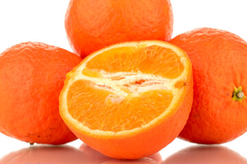 One half and three whole sweet organic tangerines, macro, isolated on white background.