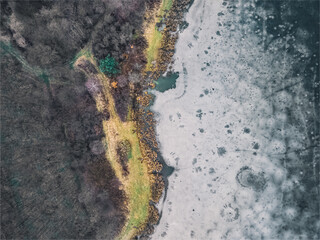 Aerial view of a frozen lake. Ice sheet background. Frozen grass on the lake. Ice background. Ice cover on a lake