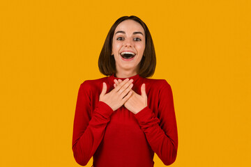 Surprised pretty woman exclaiming and touching chest