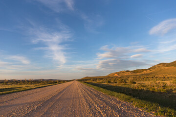 Fototapeta na wymiar Long empty dirt road in the country.