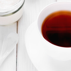 white cup of tea and sugar