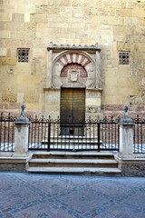 The beautiful exterior facade with a wooden door in the historic of Cordoba Spain