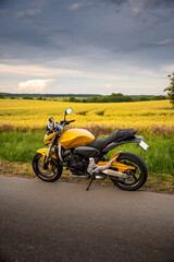 Obraz na płótnie Canvas Gold wheat field with the motorcycle