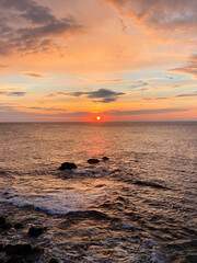 colorful sunset at sea with rocks