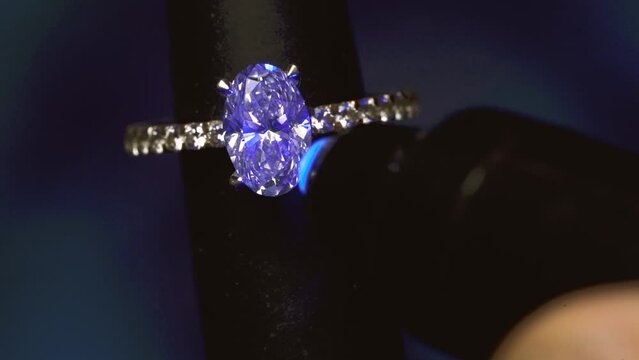 Oval Diamond Ring On Mandrel Under UV Light. - close up