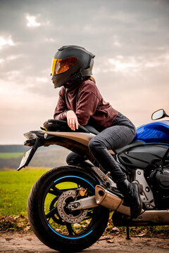 Motorbike girl posing with her thoughts