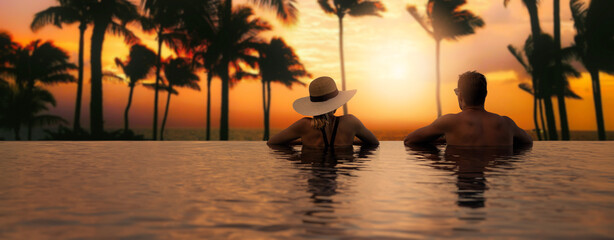 couple enjoying sunset from infinity pool at tropical island resort hotel. romantic beach getaway holiday. banner with copy space - obrazy, fototapety, plakaty