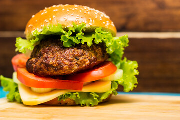 Delicious hamburgers on wooden table