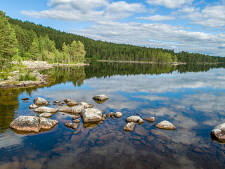 Reflections of Clouds in the Water of a Scandinavian Lake in Swedish Lapland