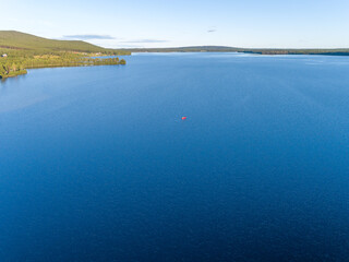Aerial View of a lonely kayak in the middle of a Scandinavian Lake in Swedish Lappland, Travel Adventure