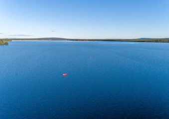 Aerial View of a lonely kayak in the middle of a Scandinavian Lake in Swedish Lappland, Travel Adventure