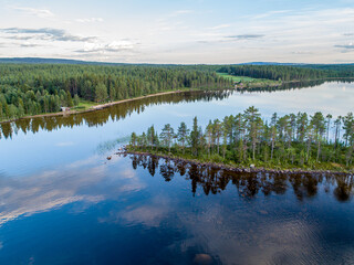 Aerial View Small Island in the Sandsjön Lake in Sandsjönäs, Swedish Lappland during Sunset with reflections in the water