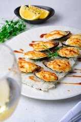 Baked mussels with cheese in shells on rice in a plate