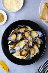 Freshly cooked mussles in wine and creamy sauce in a plate