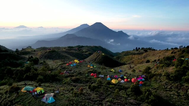 Aerial view of beauty mountain peaks Prau Dieng, Central Java and the climbers and tent. 
