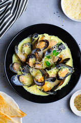 Freshly cooked mussles in wine and creamy sauce in a plate