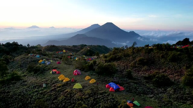 Aerial view of beauty mountain peaks Prau Dieng, Central Java and the climbers and tent. 