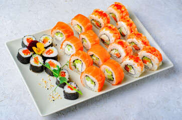 Sushi rolls set with salmon and shrimp on light blue background, Flower Shaped Sushi Rolls, Japanese cuisine