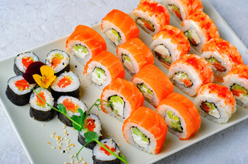 Sushi rolls set with salmon and shrimp on light blue background, Flower Shaped Sushi Rolls, Japanese cuisine