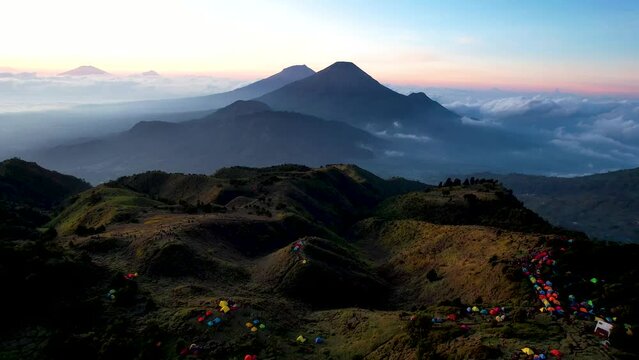 Aerial view of beauty mountain peaks Prau Dieng, Central Java and the climbers and tent. 
