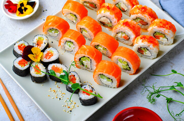 Sushi rolls set with salmon and shrimp on light blue background, Flower Shaped Sushi Rolls, Japanese cuisine