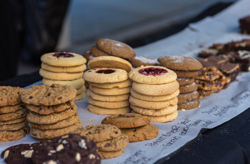 Stacks of delicious home-baked cookies and biscuits for sale at local food market in the country