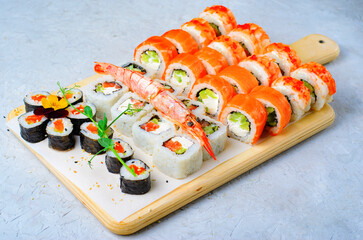 Sushi rolls set with salmon and shrimp on light blue background, Flower Shaped Sushi Rolls, Japanese cuisine