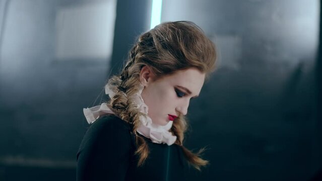 Side view frightened scared woman closing eyes putting head down imitating shut down. Portrait of talented Caucasian actress with stage makeup rehearsing emotions performing indoors