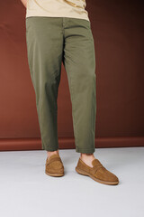 Male feet in brown suede casual shoes. Men's fashionable shoes