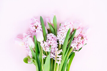 Easter scene with fresh tulips and hyacinth flowers bouquet over pink background