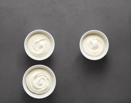 bowl of tasty mayonnaise on wooden background