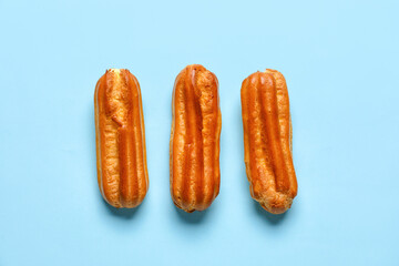 Sweet eclairs on blue background