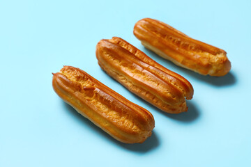 Sweet eclairs on blue background