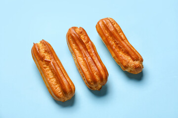 Sweet eclairs on blue background