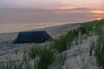 Tent on the Baltic  Sea beach on Sunrise  - 558233671