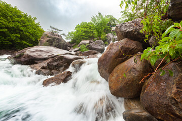 Close up view of Piagol Valley, Jirisan mountains in spring, lush forest, cascading stream and boulders, South Korea