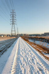 Contrast between rural and urban landscape, snow covered rice fields near Iksan, North Jeolla Province (Jeollabukdo), South Korea