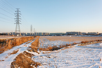 Contrast between rural and urban landscape, snow covered rice fields near Iksan, North Jeolla Province (Jeollabukdo), South Korea