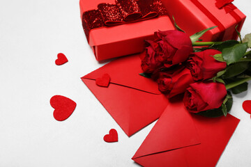Red roses, envelopes, gifts and hearts on white background, closeup. Valentine's Day celebration