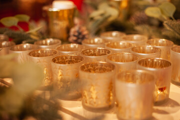 Golden glass candlesticks and tealight holders in the home decor store for retail sale