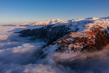 Caucasian mountains above the clouds at the sunset