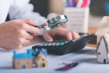 man holding magnifying glass,concept of a loan for housing,Approval of credit for the purchase of real estate,business and finance concept,home loan refinancing,Residential sale and mortgage planning