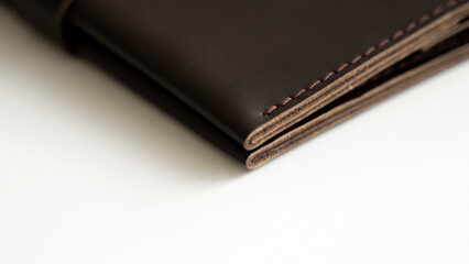 Macro shot of details of brown elegance men's wallet on a white background. Mens leather accessories.