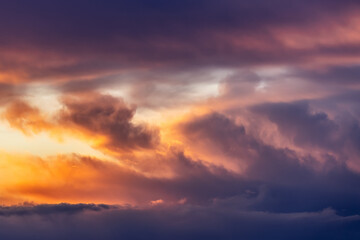 Beautiful storm cumulus clouds in the sky during sunrise or sunset, background