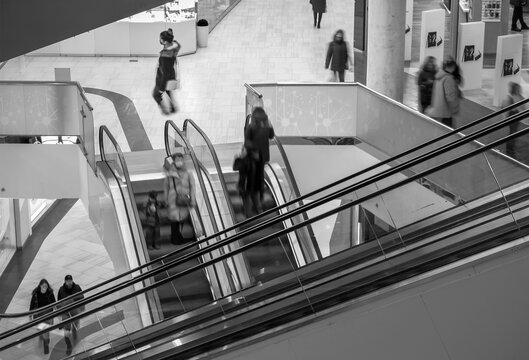 Blurred image of people on the escalator in the mall