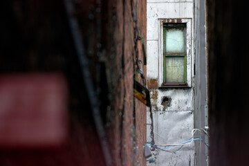 Decrepit Back Alley Window. A narrow, decrepit back alley in a rundown part of town.

