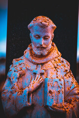 man holding a bible and a cross on his chest, already old and pure rust